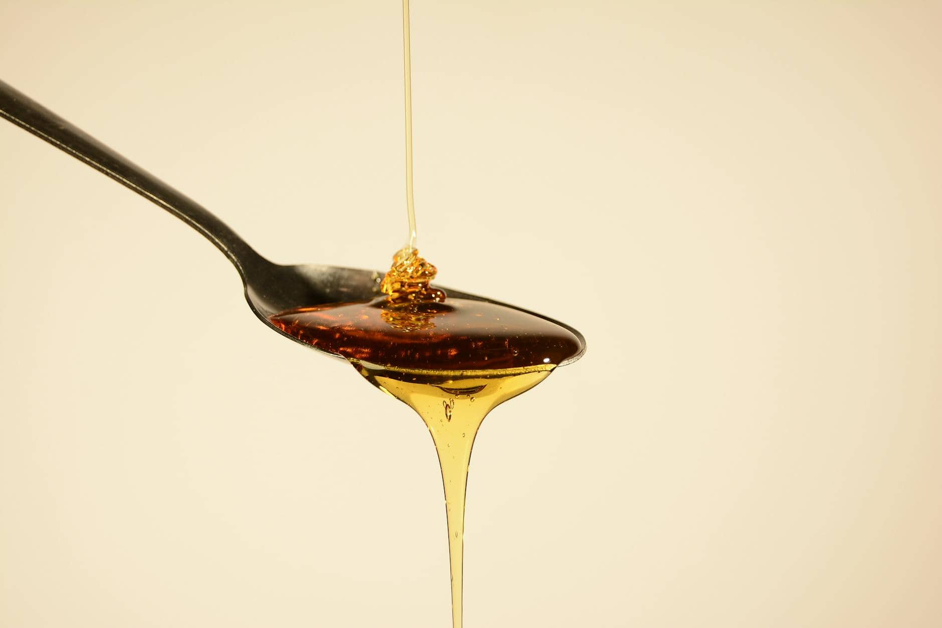 honey flowing through spoon