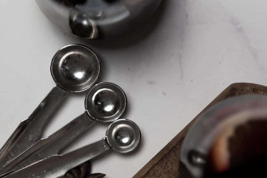 measuring spoon beside a drink