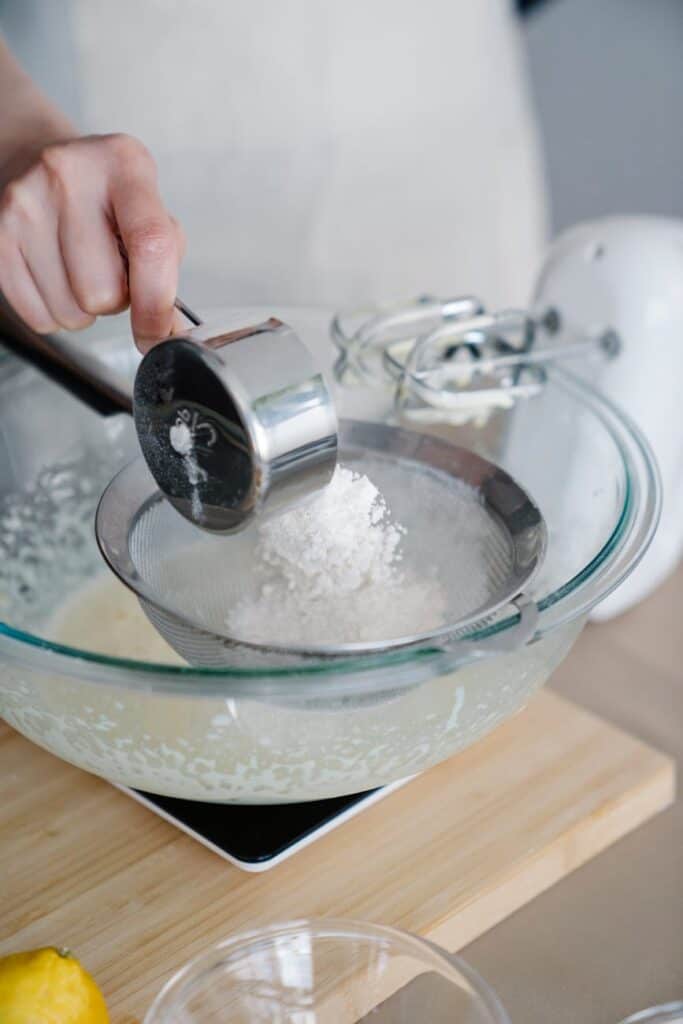 a baker straining flour