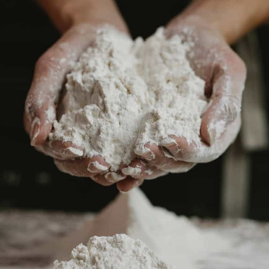 woman showing wheat flour in hands
