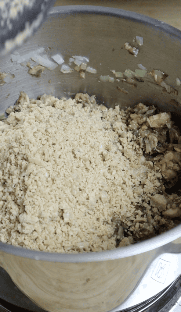 ground tempeh and mushrooms added to the pot with onions and garlic