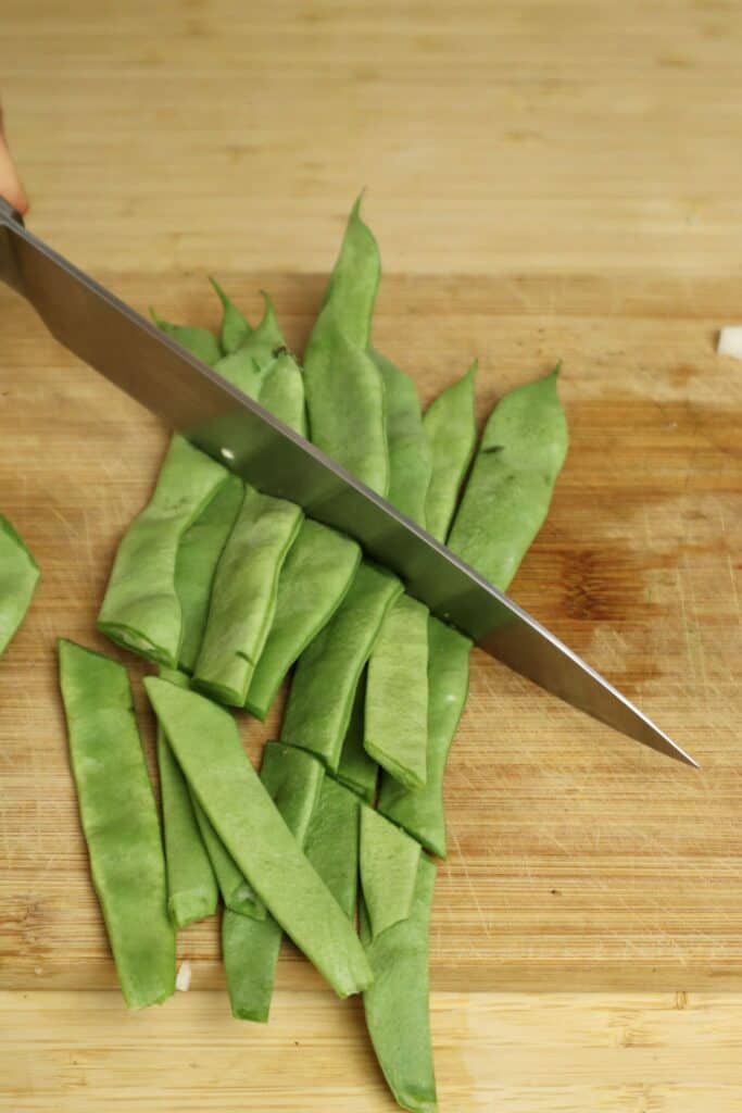 romano beans being cut